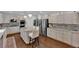 Spacious kitchen with a large island, stainless steel appliances, and hardwood floors for modern convenience at 8824 Prague Ct, Las Vegas, NV 89147