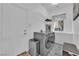 Bright laundry room features modern front load washer/dryer, folding counter, shelving, and natural light at 8824 Prague Ct, Las Vegas, NV 89147