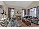 Cozy living room with a fireplace, plush sofas, and stylish decor at 8824 Prague Ct, Las Vegas, NV 89147