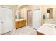 Bright bathroom featuring double sinks, ample cabinet space, and a walk-in shower, blending functionality with style at 9 Contra Costa Pl, Henderson, NV 89052