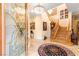 Grand foyer with marble floors, ornate staircase, elegant chandelier, and decorative front door at 9 Contra Costa Pl, Henderson, NV 89052