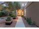 Inviting front entrance with stone walkway, manicured landscaping, and warm exterior lighting at 9 Contra Costa Pl, Henderson, NV 89052