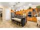 A spacious kitchen island with stone counter and wood cabinets at 9 Contra Costa Pl, Henderson, NV 89052