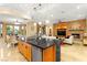Open-concept kitchen featuring an island bar, dining area, and living space at 9 Contra Costa Pl, Henderson, NV 89052