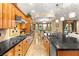 Gourmet kitchen with wooden cabinets, stainless appliances and dark countertops at 9 Contra Costa Pl, Henderson, NV 89052