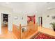 Bright upstairs landing with a wood railing and open view of the home at 9 Contra Costa Pl, Henderson, NV 89052