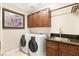 Laundry room features side-by-side washer and dryer, upper cabinets, and sink at 9 Contra Costa Pl, Henderson, NV 89052
