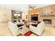 Stylish living room features a stone accent wall with a fireplace, comfortable seating, and tile floors at 9 Contra Costa Pl, Henderson, NV 89052
