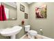 Chic powder room features a pedestal sink and decorative artwork at 9 Contra Costa Pl, Henderson, NV 89052