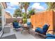 Inviting backyard patio with a fire pit, comfortable seating, and views of a rock waterfall feature at 9416 Rolling Ridge Ln, Las Vegas, NV 89134