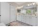 Bright bathroom featuring double sinks, a large mirror, and plenty of storage at 9416 Rolling Ridge Ln, Las Vegas, NV 89134