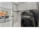 Convenient laundry room with modern appliances, cabinet storage and lots of light at 9416 Rolling Ridge Ln, Las Vegas, NV 89134
