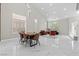Bright living room and dining area with soaring ceilings, elegant tile flooring, and ample natural light at 9416 Rolling Ridge Ln, Las Vegas, NV 89134