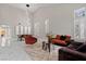 Bright living room featuring soaring ceilings, elegant tile flooring, and plenty of natural light at 9416 Rolling Ridge Ln, Las Vegas, NV 89134