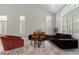 Bright living room featuring soaring ceilings, elegant tile flooring, and plenty of natural light at 9416 Rolling Ridge Ln, Las Vegas, NV 89134