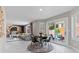Bright living room with a dining space, modern decor, and access to the patio at 9416 Rolling Ridge Ln, Las Vegas, NV 89134