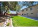 Expansive backyard with lush lawn, mature trees, and concrete patio space, perfect for outdoor living at 9750 W Cherokee Ave, Las Vegas, NV 89147