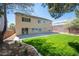 Spacious backyard featuring a well-manicured lawn, mature tree, and a patio for entertaining at 9750 W Cherokee Ave, Las Vegas, NV 89147