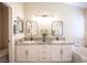 Bathroom featuring granite counters, dual sinks, and soaking tub at 9750 W Cherokee Ave, Las Vegas, NV 89147