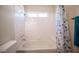 Well-maintained bathroom featuring a shower-tub combo with white tiles and a shower curtain at 9750 W Cherokee Ave, Las Vegas, NV 89147