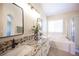 Bathroom featuring granite counters, dual sinks, soaking tub and shower at 9750 W Cherokee Ave, Las Vegas, NV 89147