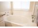 Bathroom with large soaking tub under a window and white tile surround at 9750 W Cherokee Ave, Las Vegas, NV 89147