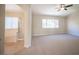 Bright bedroom with large window, adjoining bathroom, and carpeted floors at 9750 W Cherokee Ave, Las Vegas, NV 89147