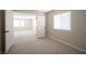 Bright bedroom boasts neutral carpet and paint with views of an adjacent room through large double doors, accentuated by natural light at 9750 W Cherokee Ave, Las Vegas, NV 89147