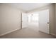 Spacious bedroom featuring neutral carpet and paint with a glimpse into another room through large, open double doors at 9750 W Cherokee Ave, Las Vegas, NV 89147