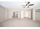 Large carpeted bedroom with ceiling fan, walk-in closet, and bathroom entrance at 9750 W Cherokee Ave, Las Vegas, NV 89147