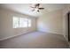 Spacious carpeted bedroom with large window and closet at 9750 W Cherokee Ave, Las Vegas, NV 89147