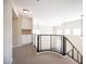 Upstairs hallway featuring a black railing, carpeting, and built-in storage at 9750 W Cherokee Ave, Las Vegas, NV 89147