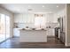 Modern kitchen with white cabinets, stainless steel appliances, and a granite island with sink at 9750 W Cherokee Ave, Las Vegas, NV 89147
