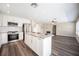 Spacious kitchen with stainless steel appliances, granite counters, and dark plank flooring at 9750 W Cherokee Ave, Las Vegas, NV 89147