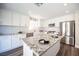 Bright, renovated kitchen with white cabinets, granite countertops, and modern stainless steel appliances at 9750 W Cherokee Ave, Las Vegas, NV 89147