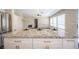 Kitchen island with granite countertop and cabinets with gold hardware and dining set up at 9750 W Cherokee Ave, Las Vegas, NV 89147