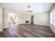 Open living room featuring dark plank flooring, fireplace, and abundant natural light at 9750 W Cherokee Ave, Las Vegas, NV 89147