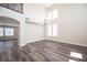 Bright living room featuring hardwood floors, a chandelier, and multiple windows at 9750 W Cherokee Ave, Las Vegas, NV 89147
