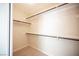 Neutral colored walk-in closet with carpet and multiple shelves and closet rods at 9750 W Cherokee Ave, Las Vegas, NV 89147