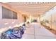 The covered back patio has an open pergola and concrete flooring, great for outdoor living at 9879 Jazzy June St, Las Vegas, NV 89183
