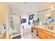 Well-lit bathroom featuring a tiled shower, soaking tub, and a spacious double sink vanity at 9879 Jazzy June St, Las Vegas, NV 89183