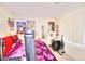 Functional bedroom with colorful posters and decorations, featuring carpet flooring, and blinds on the windows at 9879 Jazzy June St, Las Vegas, NV 89183