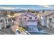 Aerial view of a cozy home, featuring a well-kept yard and a two-car garage, with a backdrop of mountains at 9879 Jazzy June St, Las Vegas, NV 89183