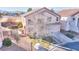 Charming two-story home with a well-manicured front yard, mature landscaping, and an attached two-car garage at 9879 Jazzy June St, Las Vegas, NV 89183