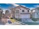 Charming two-story home featuring a well-maintained front yard and a two-car garage, complete with blue skies at 9879 Jazzy June St, Las Vegas, NV 89183