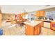 Open kitchen view featuring an island with a white tile countertop, tile flooring, and stainless steel appliances at 9879 Jazzy June St, Las Vegas, NV 89183