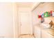 Functional laundry area with side-by-side washer and dryer, plus built-in shelving for storage at 9879 Jazzy June St, Las Vegas, NV 89183