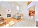 Open-concept living room with high ceilings, a fireplace, and large windows, offering a bright and airy atmosphere at 9879 Jazzy June St, Las Vegas, NV 89183
