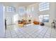 Expansive living area with tile flooring, a fireplace, and abundant natural light, showcasing the home's spacious design at 9879 Jazzy June St, Las Vegas, NV 89183