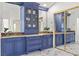 A bright bathroom with blue vanities and a double mirror at 134 Wentworth Dr, Henderson, NV 89074